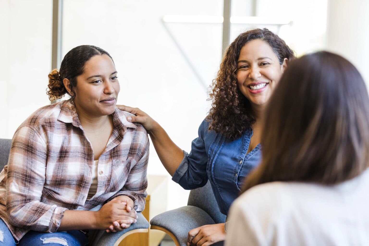 Mother and daughter meeting with a caring support coordinator
