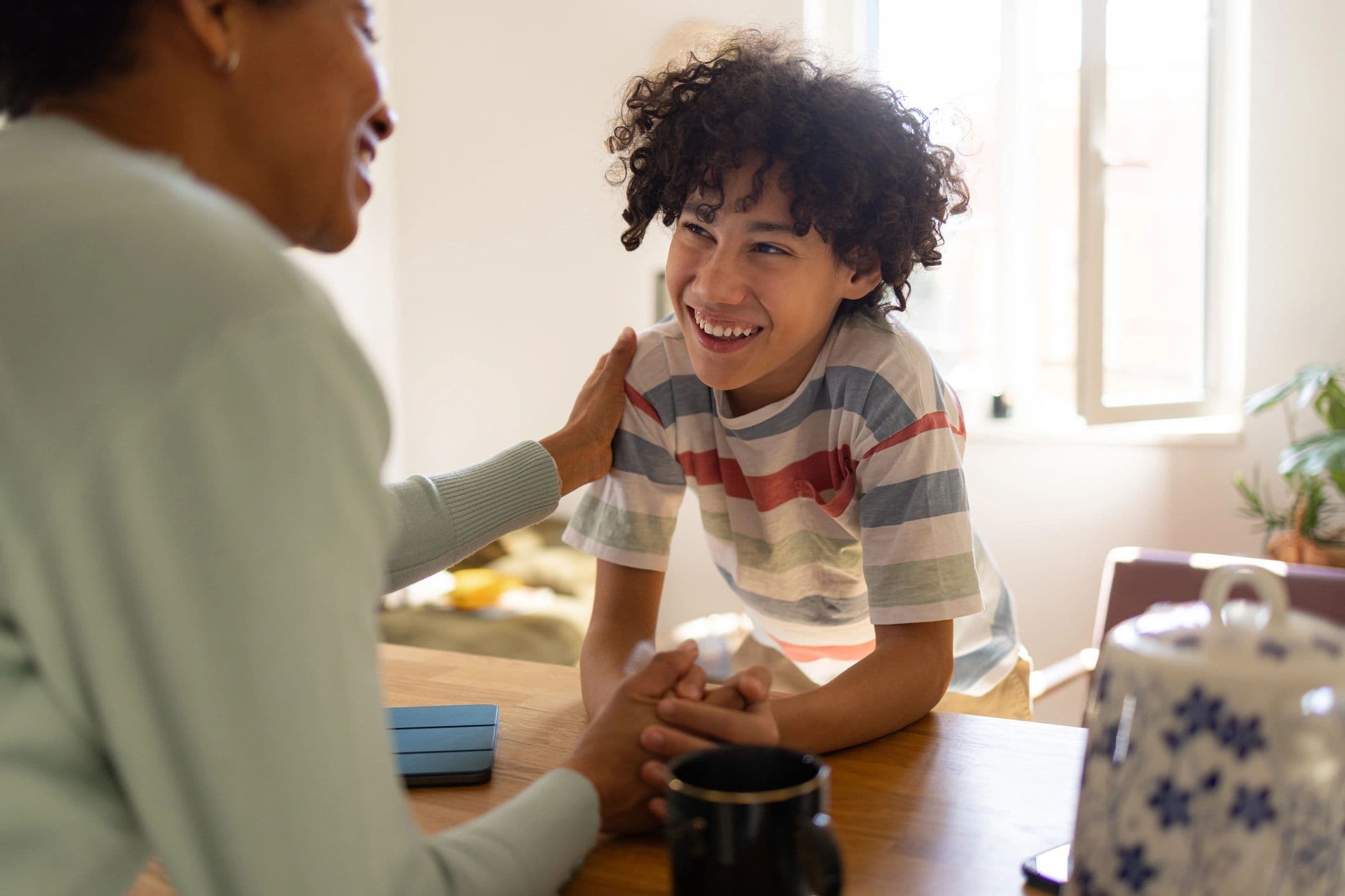 Parent and child talking together in a calm, supportive home setting